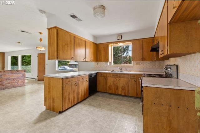 2107 Cove Ave, La Grande, OR 97850 - kitchen with electric range oven, under cabinet range hood, and brown cabinetry