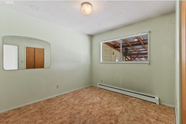 2107 Cove Ave, La Grande, OR 97850 - spare room featuring baseboard heating, carpet, and a textured ceiling