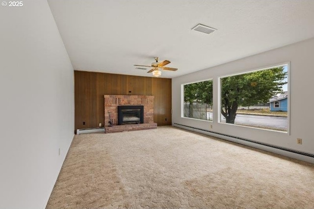 2107 Cove Ave, La Grande, OR 97850 - unfurnished living room featuring healthy amount of natural light, wooden walls, ceiling fan, and a baseboard radiator