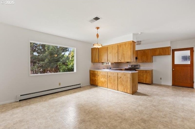 2107 Cove Ave, La Grande, OR 97850 - kitchen with a baseboard heating unit, stainless steel electric stove, brown cabinetry, a peninsula, and light countertops
