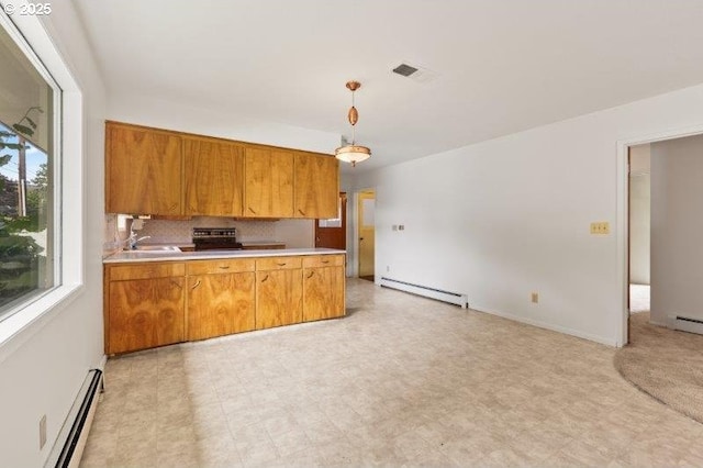 2107 Cove Ave, La Grande, OR 97850 - kitchen featuring baseboard heating, brown cabinets, and light countertops