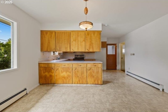 2107 Cove Ave, La Grande, OR 97850 - kitchen with a baseboard radiator, plenty of natural light, and stove