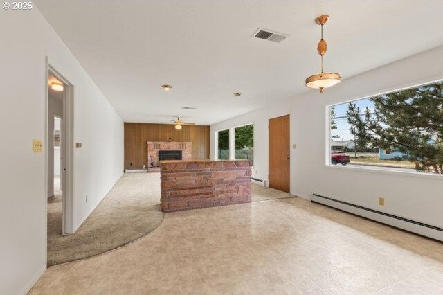 2107 Cove Ave, La Grande, OR 97850 - unfurnished living room with a fireplace, ceiling fan, wood walls, baseboard heating, and a baseboard heating unit