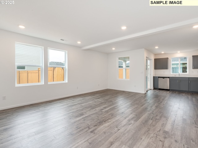 5506 NE 66th Pl, Vancouver, WA 98661 - unfurnished living room featuring wood finished floors, baseboards, a sink, and recessed lighting