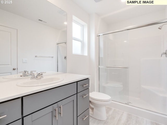 5506 NE 66th Pl, Vancouver, WA 98661 - bathroom featuring toilet, wood finished floors, vanity, visible vents, and a shower stall