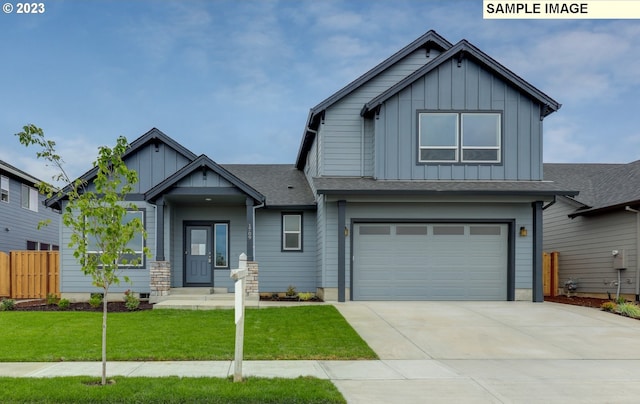 craftsman-style house featuring a front lawn and a garage