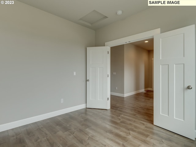 empty room with light hardwood / wood-style flooring