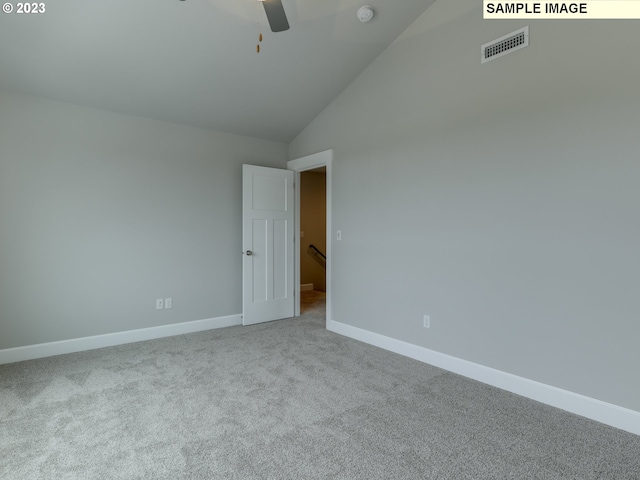 carpeted spare room with high vaulted ceiling and ceiling fan