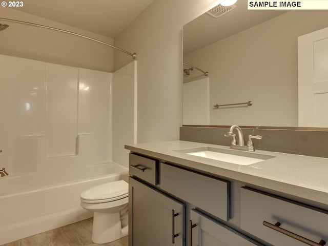 full bathroom with hardwood / wood-style flooring, vanity, toilet, and shower / bathing tub combination