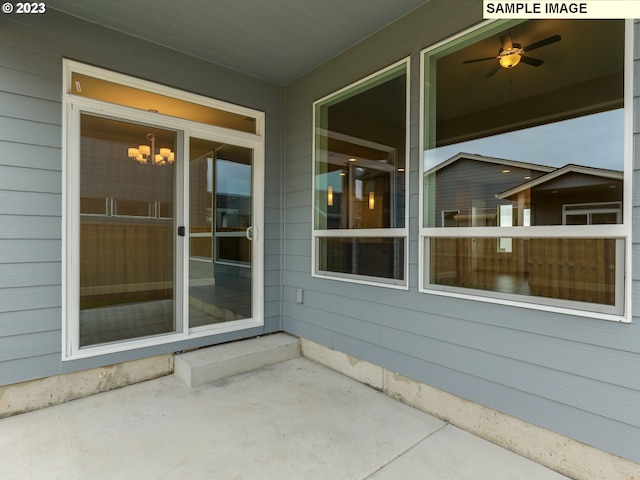 doorway to property featuring ceiling fan and a patio area