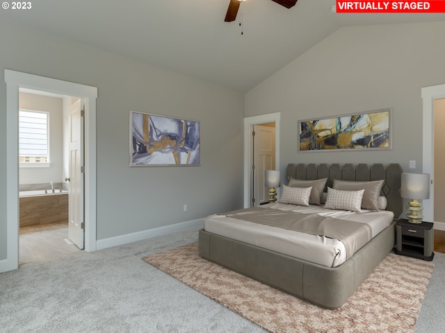 carpeted bedroom with high vaulted ceiling, ceiling fan, and ensuite bath