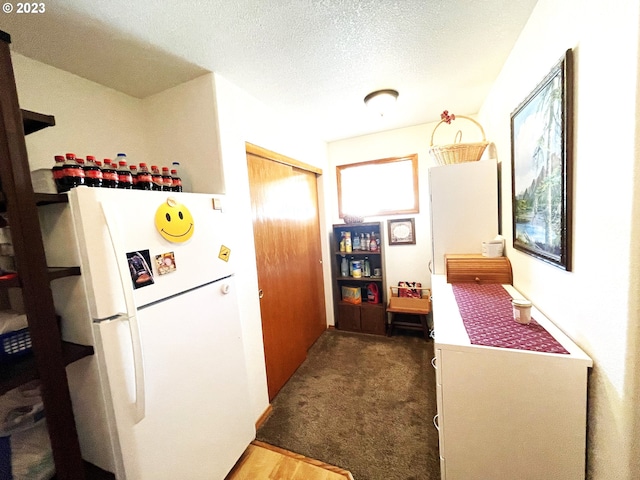 corridor with carpet floors and a textured ceiling