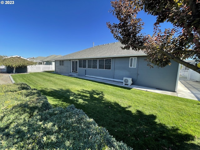 rear view of property with a yard