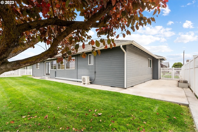 rear view of house featuring a yard and a patio area