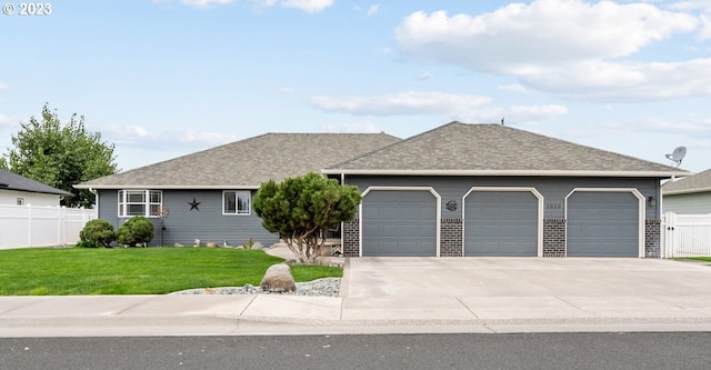 ranch-style home with a front yard and a garage