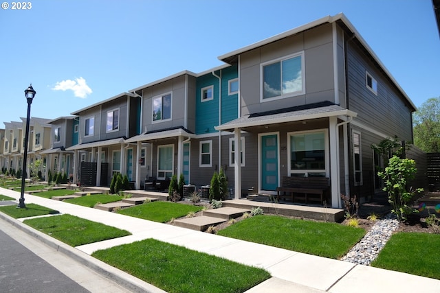 view of front of house with central air condition unit and covered porch