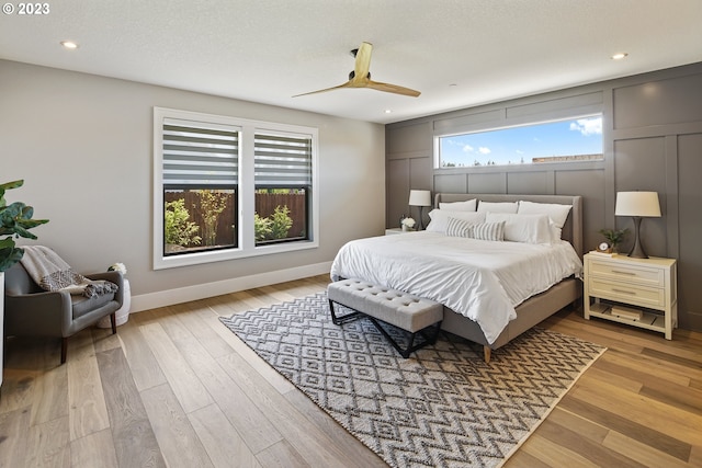 bedroom with ceiling fan and light hardwood / wood-style floors