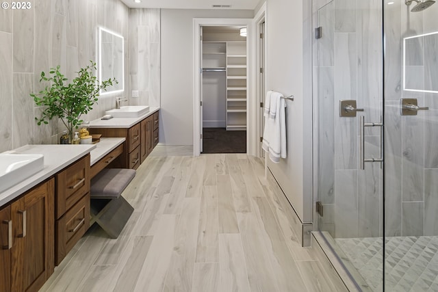 bathroom featuring vanity and a shower with shower door