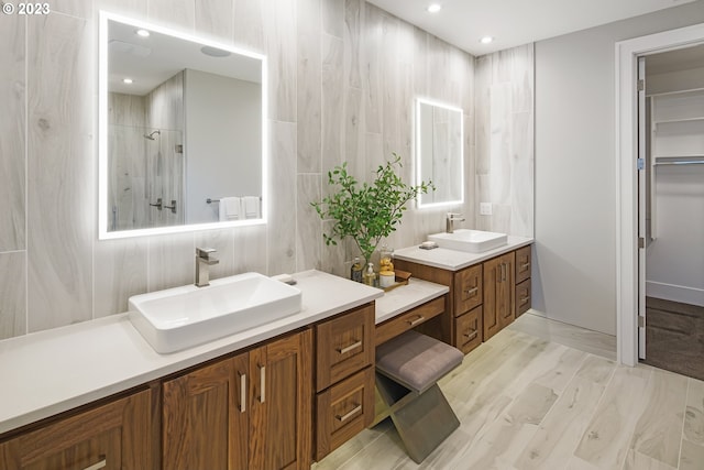 bathroom with tile walls, hardwood / wood-style flooring, and double vanity