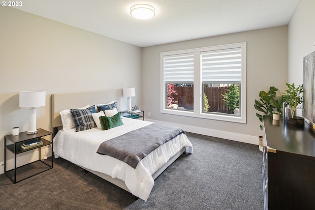 bedroom with dark colored carpet