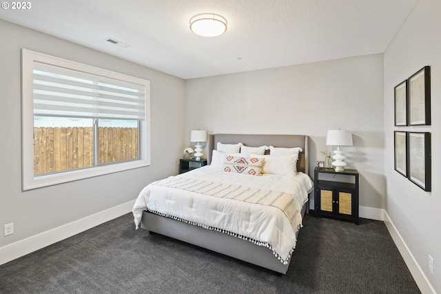 bedroom with dark carpet