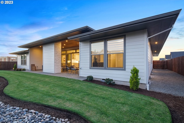 view of front facade with a patio and a yard