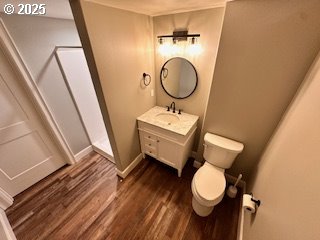 1427 SE 109th Ave, Portland, OR 97216 - bathroom featuring wood finished floors, vanity, toilet, and baseboards