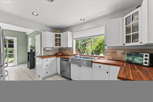 5850 SW Vermont St, Portland, OR 97219 - kitchen with wood counters, appliances with stainless steel finishes, a sink, decorative backsplash, and recessed lighting