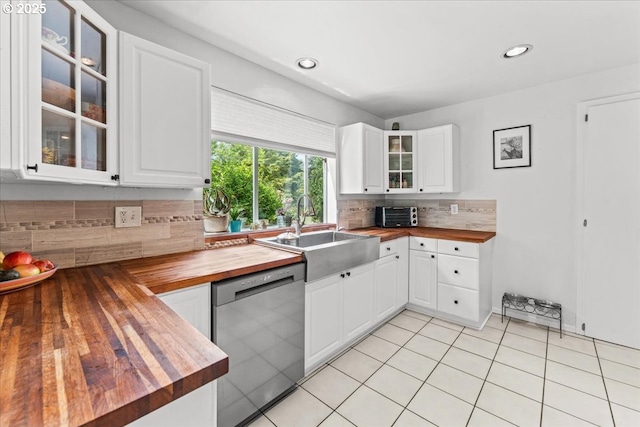 5850 SW Vermont St, Portland, OR 97219 - kitchen with wood counters, dishwasher, a sink, decorative backsplash, and glass insert cabinets