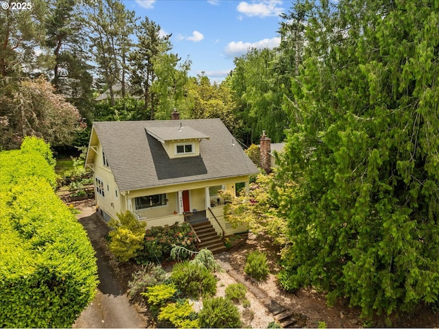 5850 SW Vermont St, Portland, OR 97219 - view of front of property featuring a porch, a chimney, stairs, and roof with shingles