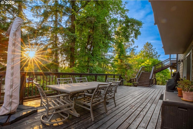deck featuring stairs and outdoor dining area