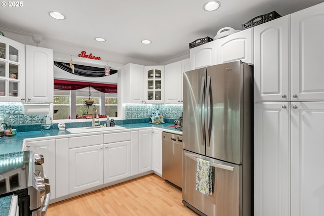11215 NE 359th St, La Center, WA 98629 - kitchen featuring stainless steel appliances, a sink, decorative backsplash, glass insert cabinets, and white cabinetry