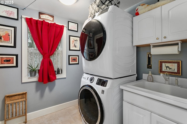 11215 NE 359th St, La Center, WA 98629 - washroom featuring stacked washer and clothes dryer, baseboards, and cabinet space