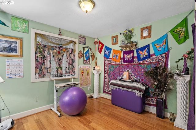 11215 NE 359th St, La Center, WA 98629 - exercise room with wood finished floors, baseboards, and a textured ceiling