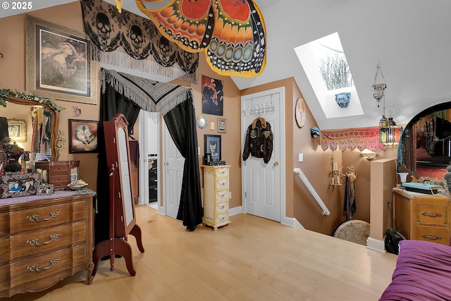 11215 NE 359th St, La Center, WA 98629 - bedroom with a skylight, wood finished floors, vaulted ceiling, and baseboards