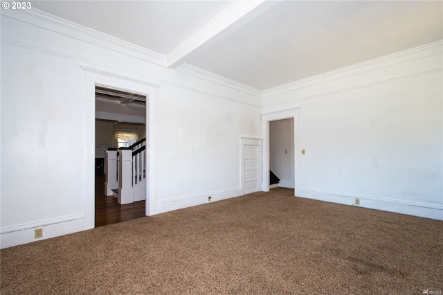 carpeted spare room featuring crown molding and beam ceiling