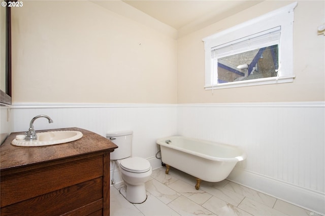 bathroom featuring vanity, tile flooring, a bathtub, and toilet