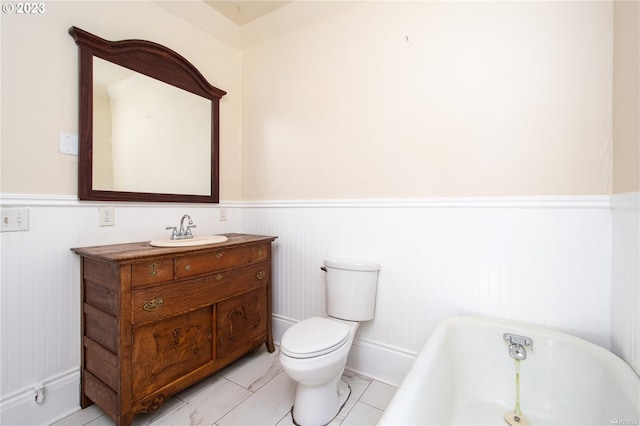 bathroom with oversized vanity, toilet, tile floors, and a bathtub