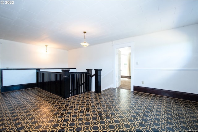 spare room featuring dark tile flooring