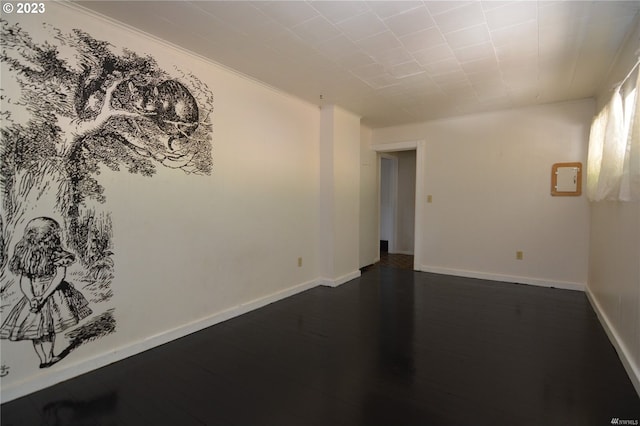 unfurnished room featuring crown molding and dark hardwood / wood-style flooring