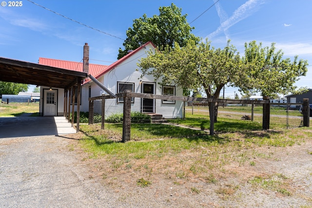 2604 15th St, Baker City, OR 97814 - view of front of home featuring a carport, a chimney, metal roof, and driveway