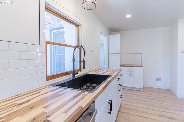 2604 15th St, Baker City, OR 97814 - kitchen featuring wood counters, a sink, light wood-type flooring, white cabinets, and recessed lighting