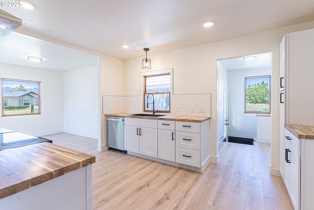 2604 15th St, Baker City, OR 97814 - kitchen with wooden counters, dishwasher, a sink, light wood-style flooring, and decorative backsplash