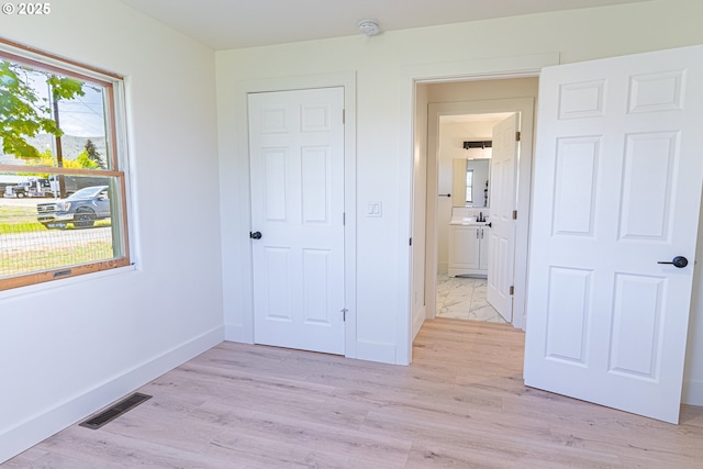 2604 15th St, Baker City, OR 97814 - unfurnished bedroom featuring baseboards, light wood-style floors, and a sink