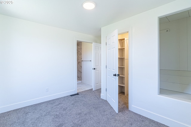 2604 15th St, Baker City, OR 97814 - unfurnished bedroom with a walk in closet, carpet, a closet, baseboards, and connected bathroom