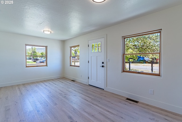 2604 15th St, Baker City, OR 97814 - entrance foyer with light wood-type flooring, baseboards, and a textured ceiling