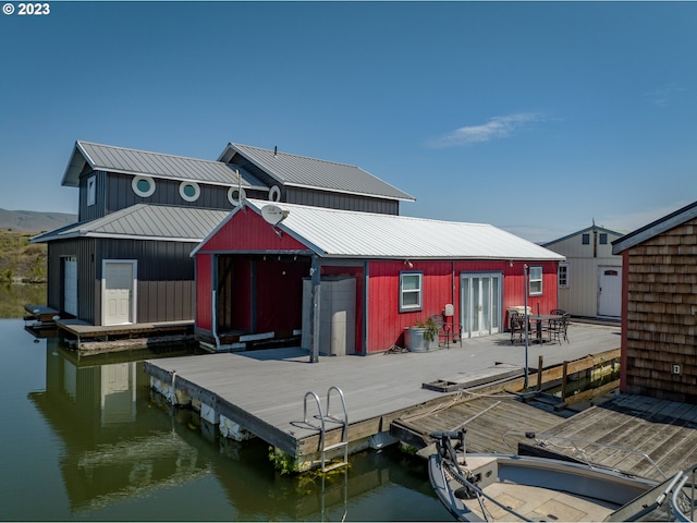 rear view of house featuring a water view