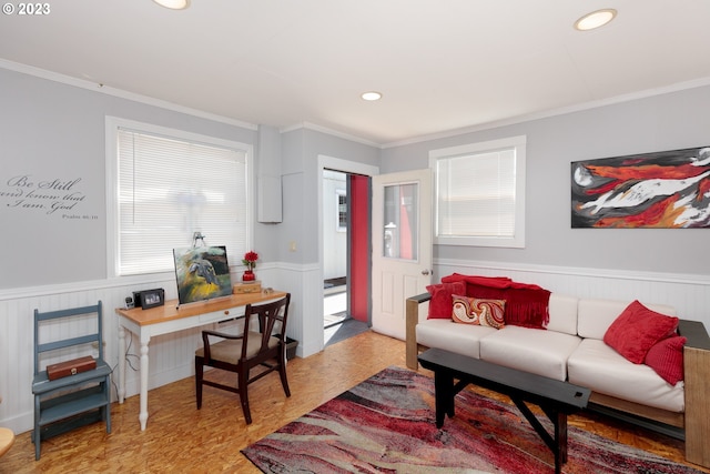 living room with crown molding and light hardwood / wood-style floors