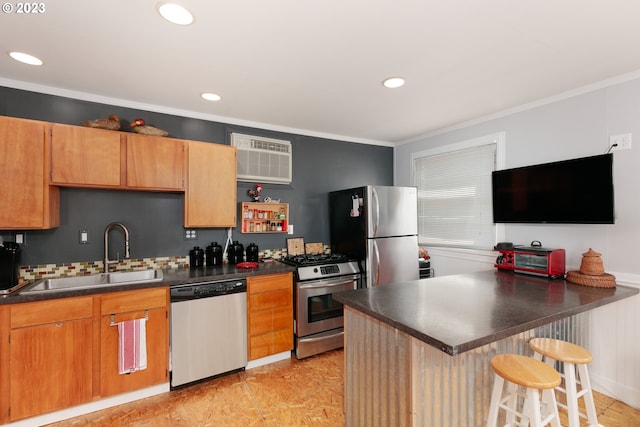 kitchen with stainless steel appliances, sink, a wall mounted AC, ornamental molding, and a kitchen breakfast bar