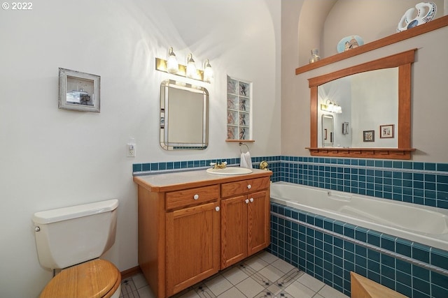 bathroom featuring tile flooring, toilet, and tiled bath